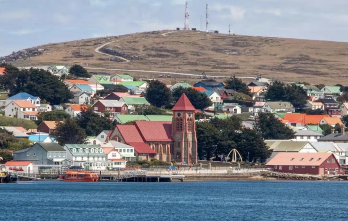 Stanley waterfront seen from the harbour, with Christ Church Cathedral, the Whalebone Arch and the public jetty